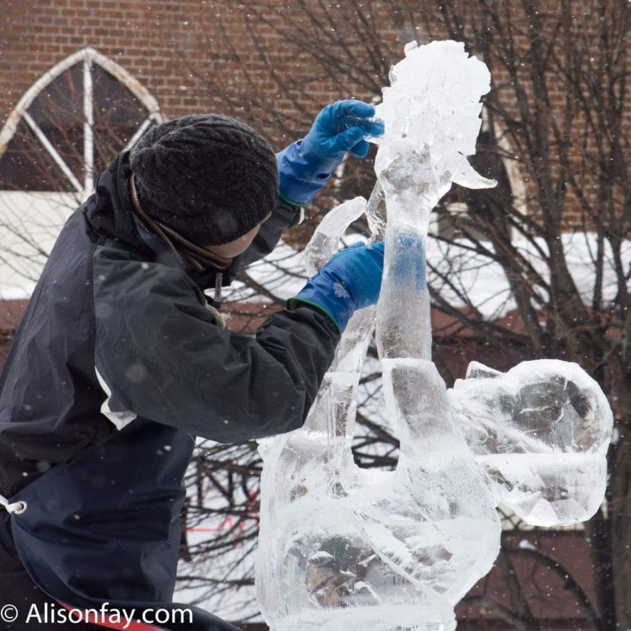 Sculptor at work on his sculpture, adding ice flowers to a bouquet, during the Asahikawa Winter Festival.