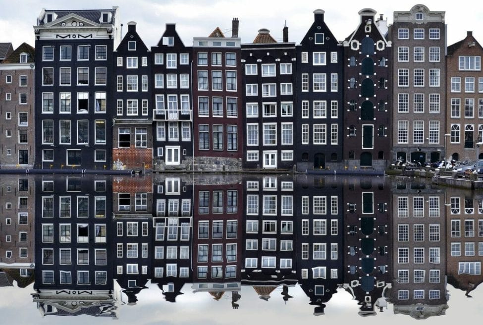 Photo of Dutch buildings in Amsterdam, reflecting in the amsterdam canals.