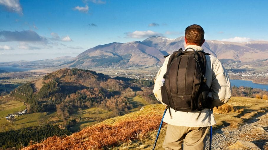 Fell walking on catbells mountain in the Lake District with a scenic panorama view of Derwentwater lake and Keswick in the background