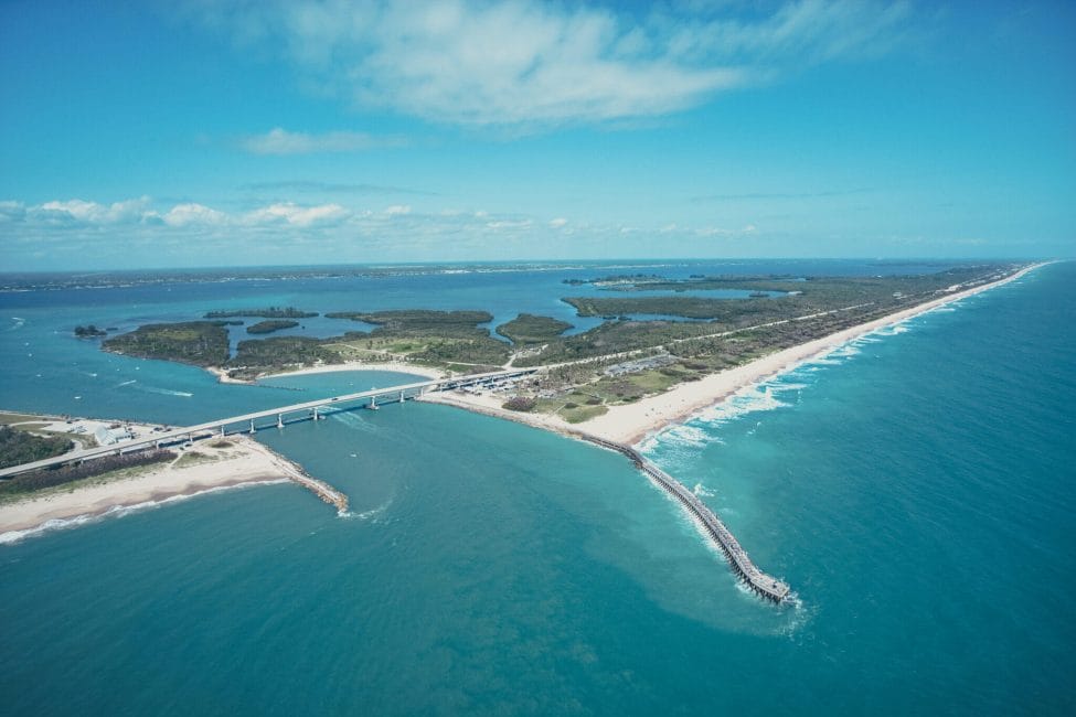 Aerial view of Indian River Lagoon Scenic Highway on Melbourne Beach, Florida with inlet and pier.