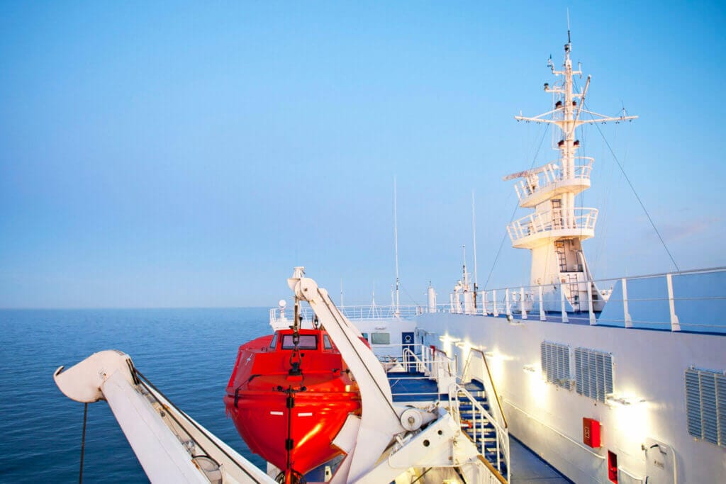 Photo of part of a ferry ship, taken on board viewing the liferaft and outter deck area.