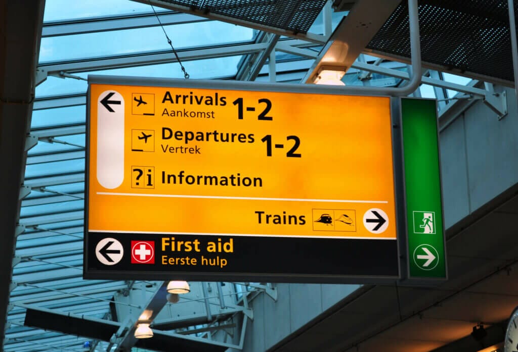 Sign at Schiphol aIrport showing way to arrivals 1-2