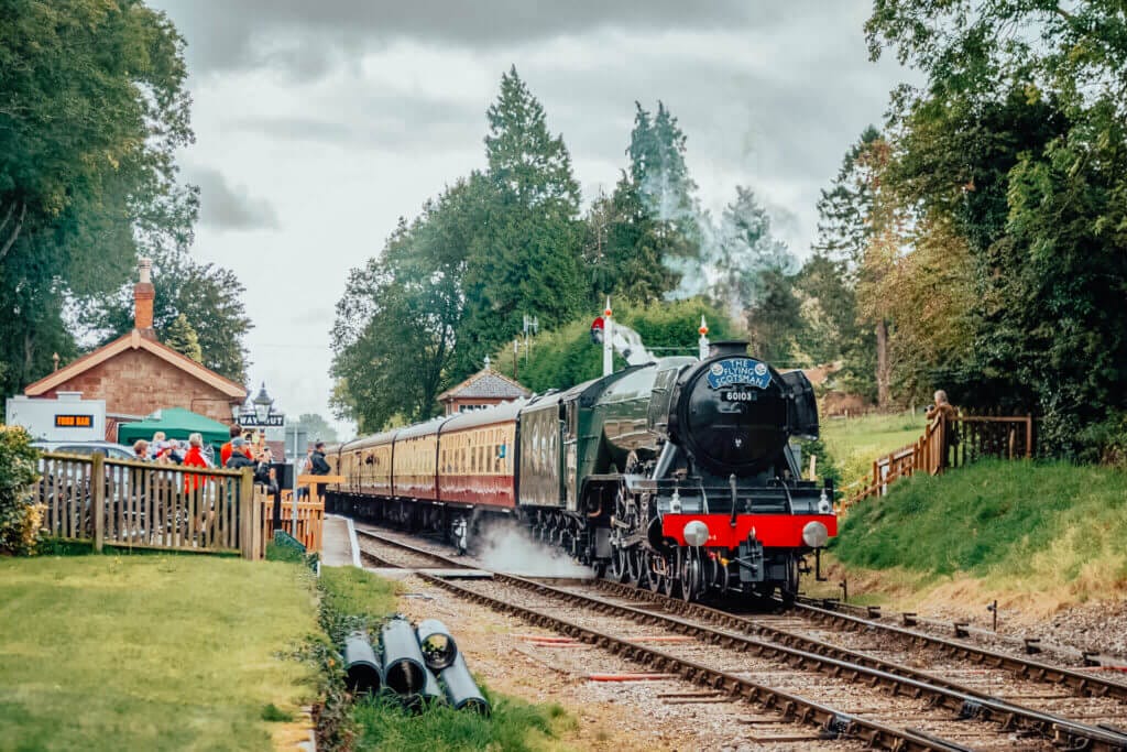 The Flying Scotmans Steam train on the West Somerset Railwaym, travelling through a train station