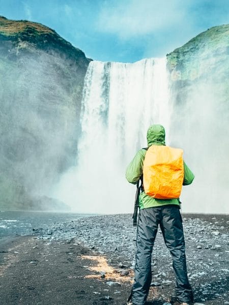 Man with rainproof pants and rainproof backpack cover in Iceland