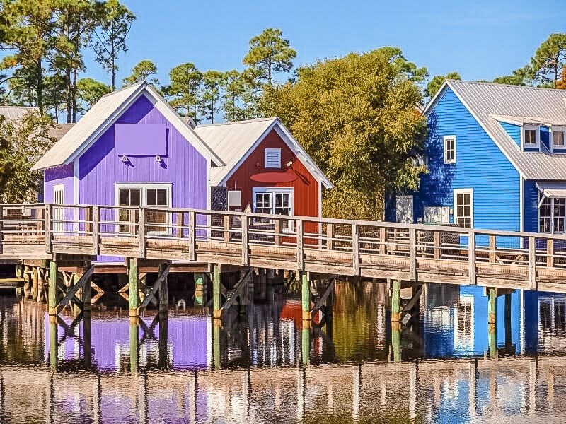 Shops at baytowne wharf, showing the colourful lilac, red and blue buildings. 