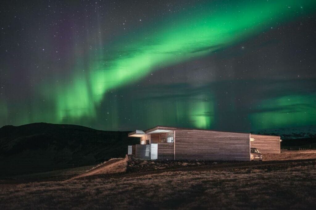 Northern lights over the black beach suites aparthotel near Vik