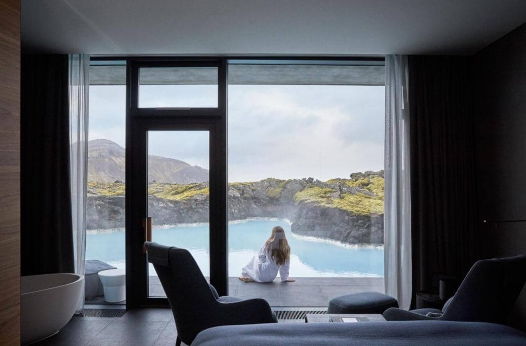 Woman sat outside her hotel room at The Retreat hotel in Iceland