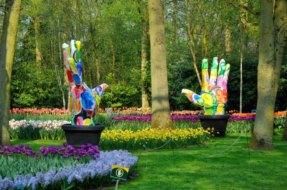 Groene Vingers (Big colorful hands) with tulips in Keukenhof park in Holland