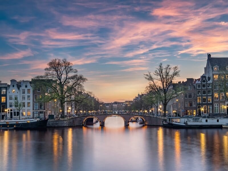 Photo of the bridge at the Amstel River during sunset. 