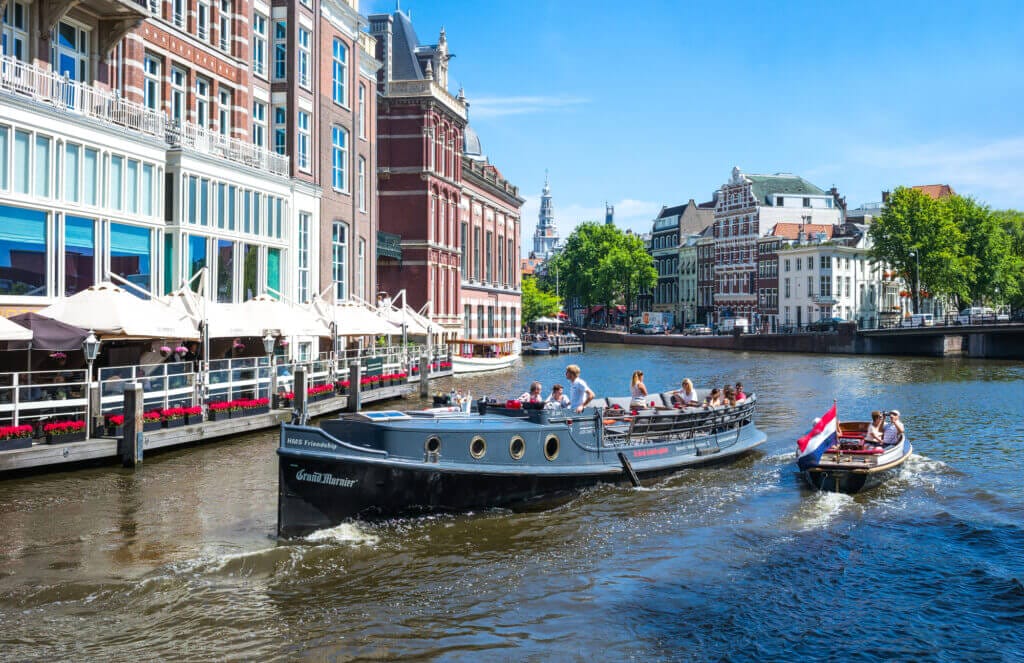 Friendship Amsterdam boat cruising along, view from  Munt Plein Amstel in Amsterdam.