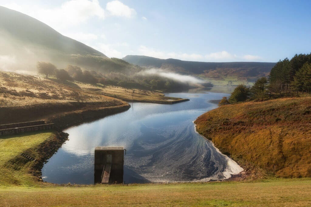 Spillway at the Dove stones reservoir with slightly mist and blue sky , Oldham, Saddleworth,