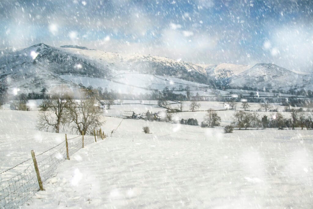 Snow covered Winter landscape at sunrise in Peak District in England 