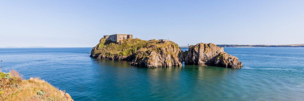 Panoroma of Saint Catherine's island and fort at the coast of Tenby on a hot summer day, Wales, UK. A picturesque and colorful village on the coast of Wales.