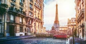 small paris street with view on the famous paris eifel tower on a cloudy rainy day with some sunshine